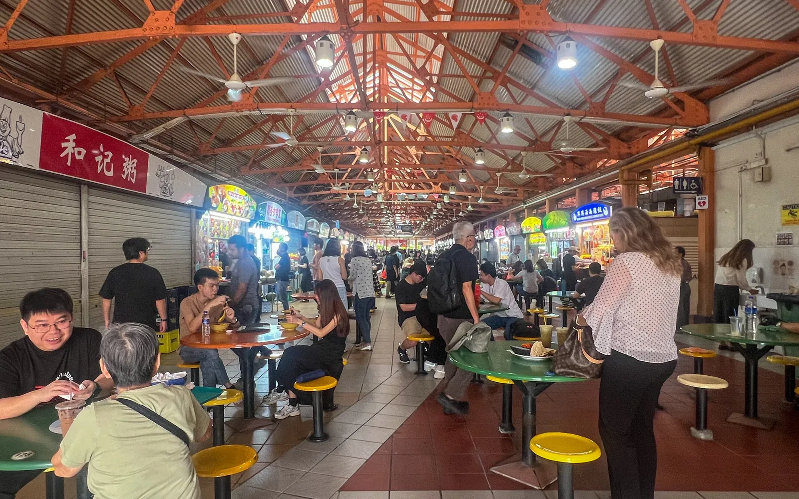 Diners and food stalls inside Maxwell Food Centre, Singapore.