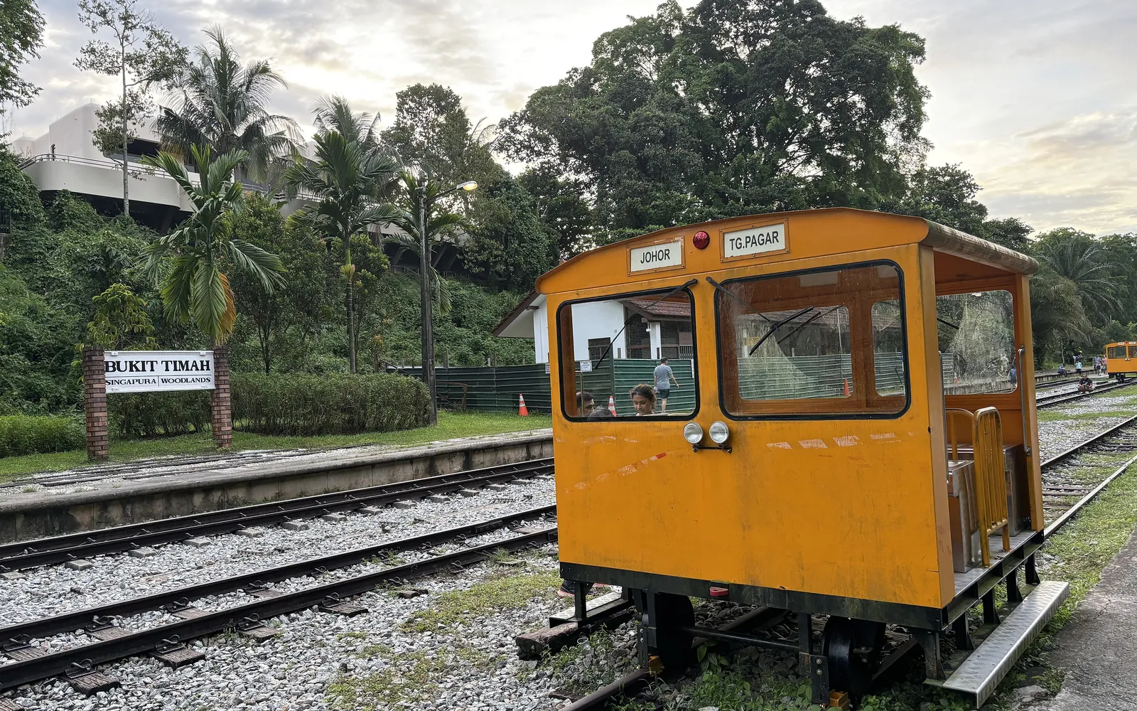 Restored railway tracks and a yellow wagon at Bukit Timah Railway Station.